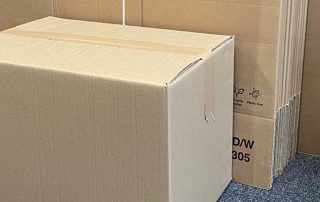 Flat packed cardboard boxes used by Pooley Removals