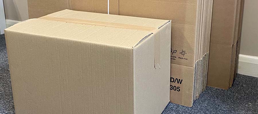 Flat packed cardboard boxes used by Pooley Removals