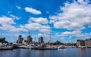 An image of Ipswich Waterfront in sunny conditions. The scenic view of boats and the buildings along the waterfront