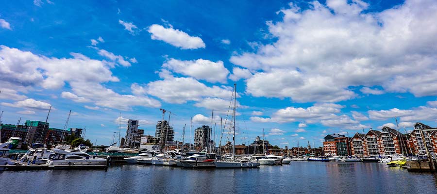 An image of Ipswich Waterfront in sunny conditions. The scenic view of boats and the buildings along the waterfront