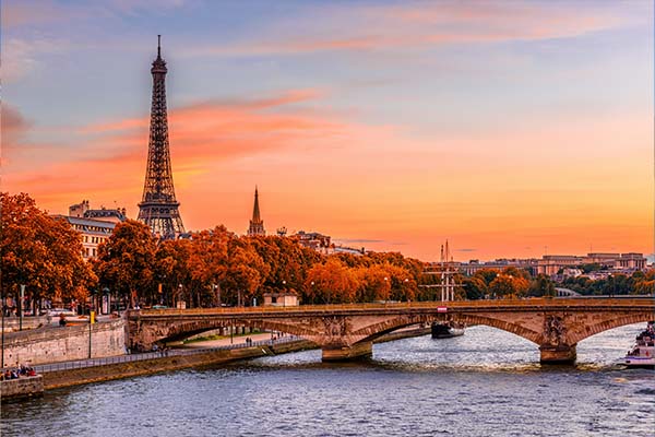 A distant view of the Eiffel Tower in Paris, France at sunset